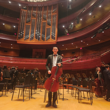  Photo of Son Nguyen holding instrument at performance